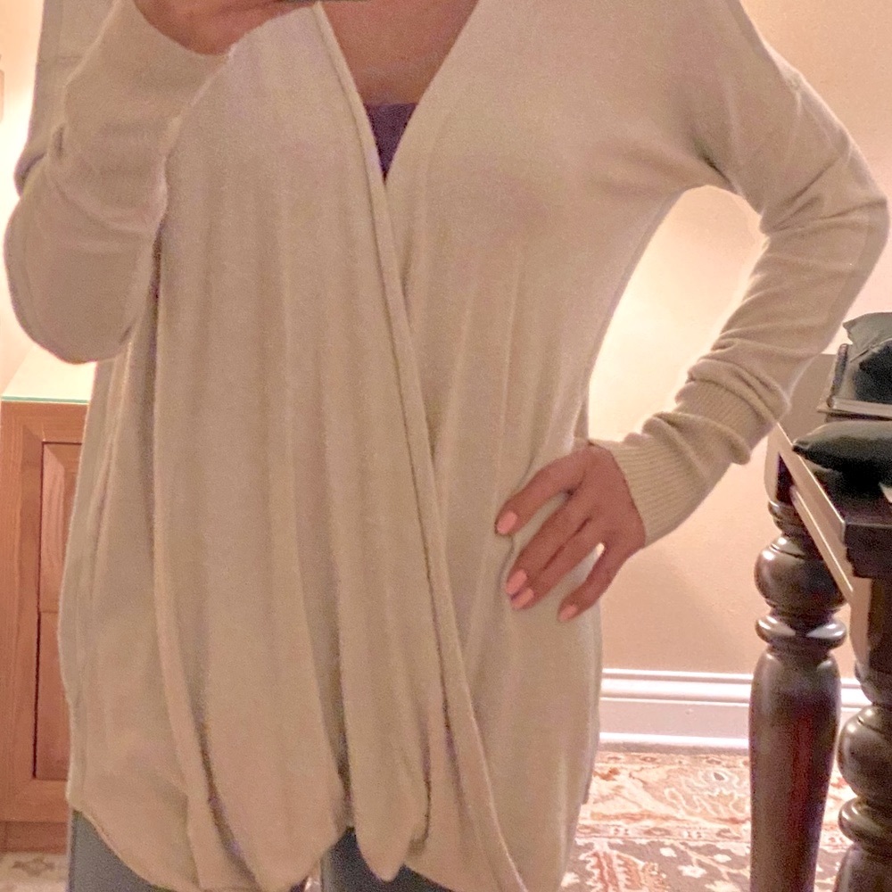 Lovestich sweater with a front wrap draped style.